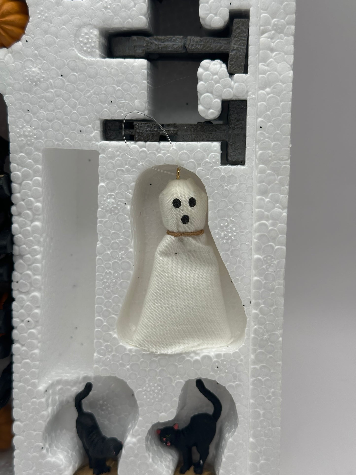 Original packaging of the Department 56 Snow Village Halloween set with contents showing the ghost close-up.