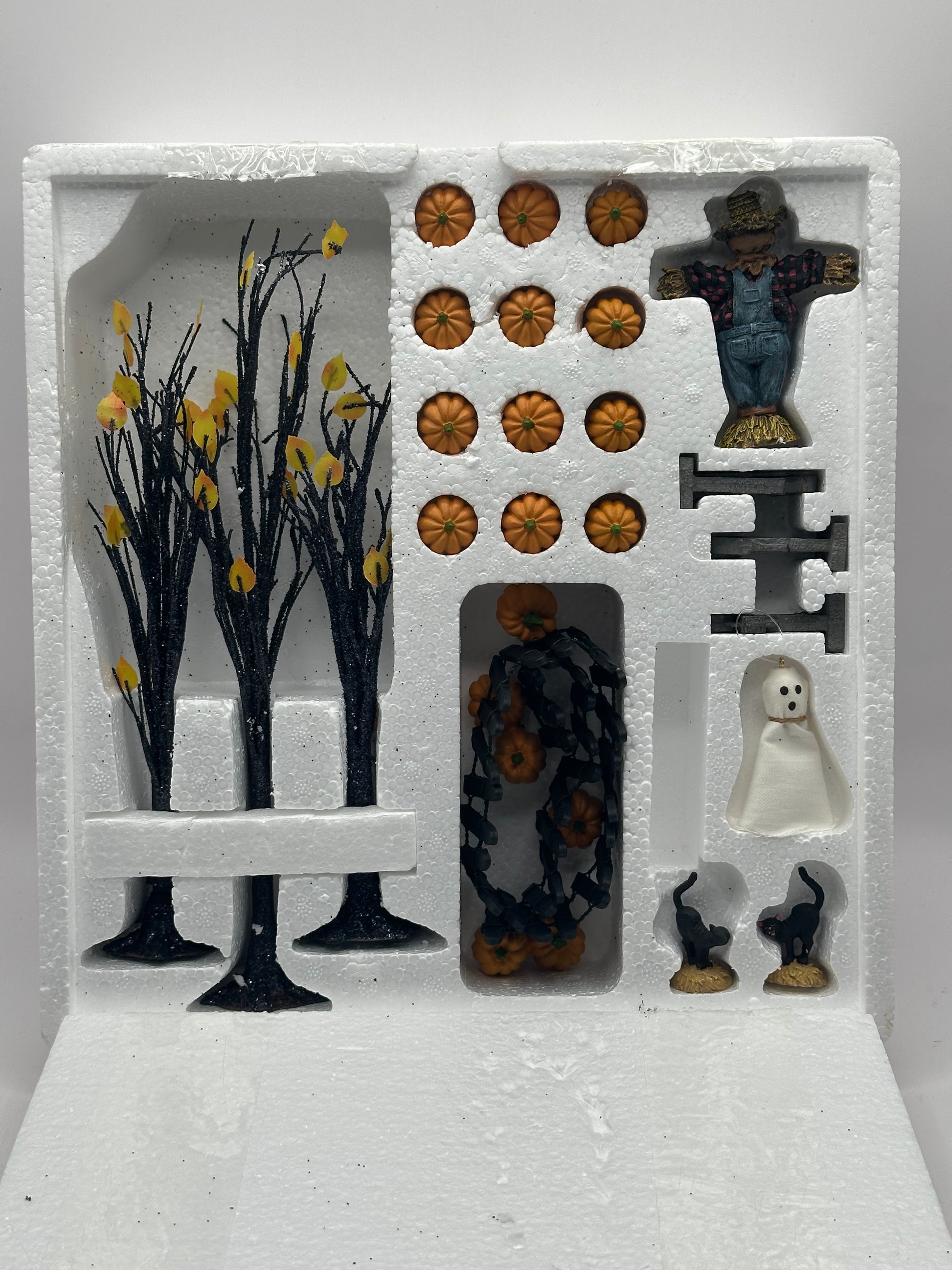 Original packaging of the Department 56 Snow Village Halloween set with contents showing.